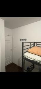 a bedroom with a bunk bed and a white wall at Welcome Home in Piaseczno