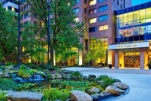 a garden with a pond in front of a building at Sheraton Baltimore North in Towson