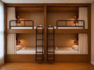a room with three bunk beds in a room at Welcome Hostel in Churriana +5 photos