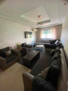 a large living room with couches and a couch at Hanae malabata in Tangier