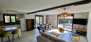 a living room with a couch and a table with chairs at Le Balcon de Narlay in Le Frasnois