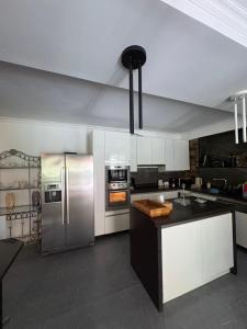 a kitchen with a stainless steel refrigerator and appliances at Ninika B&B Utsera in Oni