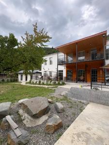 a large building with rocks in front of it at Ninika B&B Utsera in Oni