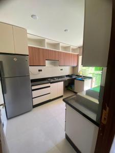 a kitchen with stainless steel appliances and wooden cabinets at Hanae malabata in Tangier