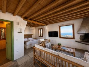 a large living room with a couch and a bed at Sifnos Roots in Exámbela
