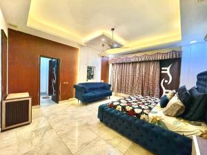 a living room with a bed and a couch at Moonlight Stays in Gurgaon