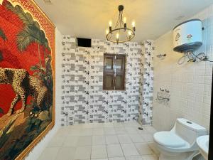 a bathroom with a cheetah mural on the wall at Moonlight Stays in Gurgaon
