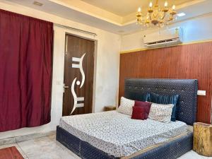 a bedroom with a bed and a red curtain at Moonlight Stays in Gurgaon