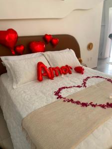 a bed with red hearts on top of it at Natureza e luxo in Alagoa Nova