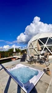a hot tub on a patio with a tent at Natureza e luxo in Alagoa Nova