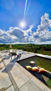 a patio with a pool and a table and chairs at Natureza e luxo in Alagoa Nova