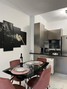 a dining room with a table and chairs and a kitchen at Salamina Downtown Apartment East in Salamina