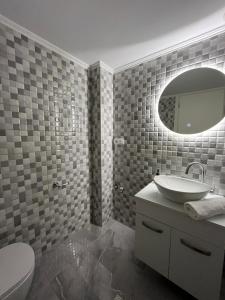 a bathroom with a sink and a mirror at Salamina Downtown Apartment East in Salamina