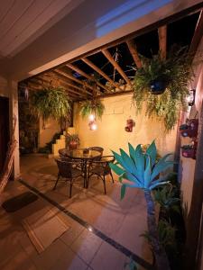 a patio with a table and chairs and plants at Pousada Costa dos Corais in Mangaratiba