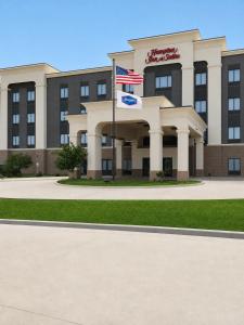 an office building with a flag in front of it at Hampton Inn & Suites Woodward in Woodward