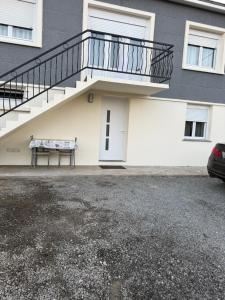 a building with a staircase and a bench in front of it at Maison Charmante in Donges