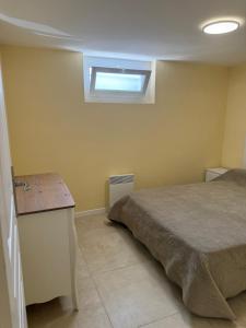 a bedroom with a bed and a window on the wall at Maison Charmante in Donges
