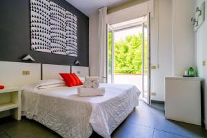 a bedroom with a bed with two towels on it at Hotel La Bussola in Marina di Massa +81 photos