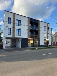 a building on the side of a street at Golden Sky Residence in Satu Mare