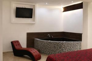 A television and/or entertainment centre at First Inn Hotel & Business