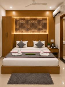 a bedroom with a large bed in a room at Hotel Rose Inn in Prayagraj