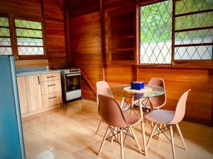 a kitchen with a table and chairs in a room at Huayra Wasy in Tena