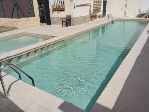 a swimming pool with blue water in a building at Chalet Puerto Marina Goya in Benalmádena