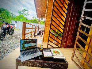 a laptop computer sitting on a table next to a door at Huayra Wasy in Tena