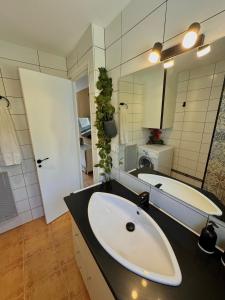 a bathroom with a sink and a mirror and a tub at Casa Pont in Osséja