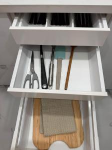 a shelf with knives and other kitchen utensils at Cura Marina 2 in Playa del Cura