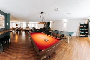 a living room with a pool table and ping pong ball at Pimishka Chalet-Cottage-Studios in Bouchette