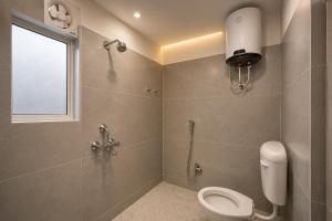 a bathroom with a shower and a toilet and a window at Hotel Prince Paradise in Patna +20 photos