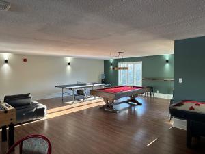 a living room with two ping pong tables in it at Pimishka Chalet-Cottage-Studios in Bouchette