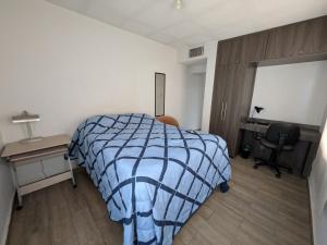 a bedroom with a bed and a desk and a chair at Zona nuevo CAMPUS Universidad departamento independiente in Chihuahua +7 photos