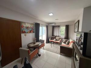 a living room with a couch and a table at Apartamento Unisc in Santa Cruz do Sul