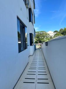 a hallway of a white building with windows at Apartamento Unisc in Santa Cruz do Sul