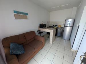 a living room with a couch and a kitchen at Departamento privado zona de la UACH in Chihuahua
