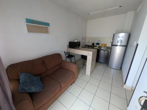 a living room with a couch and a kitchen at Departamento privado zona de la UACH in Chihuahua +12 photos