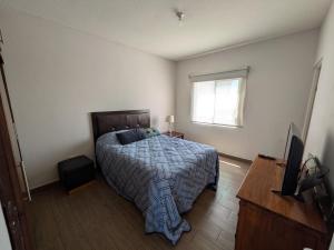 a bedroom with a bed and a television and a window at Departamento EMPRESARIAL cerca de zona industrial in Chihuahua +15 photos