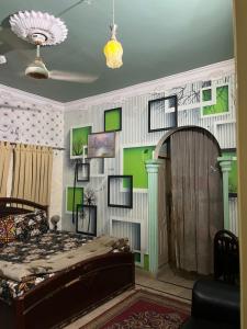 a bedroom with green and white walls and a bed at Faran inn guest house in Hyderabad