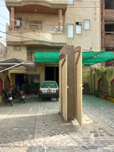 a building with a door open in a parking lot at Faran inn guest house in Hyderabad