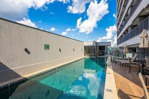 a swimming pool in the side of a building at Apts in a Building with Pool and Gym - GRL in Anápolis