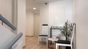 a room with a table and chairs and a staircase at Albergue EL CASTILLO in Sarria +13 photos