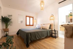 a bedroom with a bed and a couch and a window at Porta Toscana in Poggibonsi