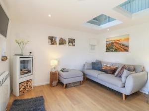 a living room with a couch and a tv at Little Barn in Leek