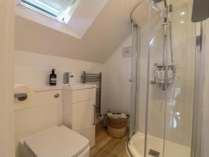 a bathroom with a toilet and a glass shower at Little Barn in Leek +18 photos