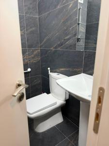 a bathroom with a white toilet and a sink at Hotel, Bar, Restaurant Beni in Vlorë