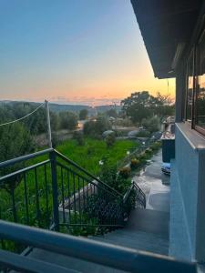 a balcony of a building with a sunset in the background at Hotel, Bar, Restaurant Beni in Vlorë