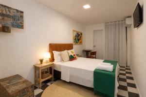 a bedroom with a bed and a television in it at Pousada Mangaba Sergipe in Aracaju