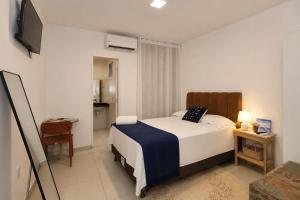 a bedroom with a bed and a television in it at Pousada Mangaba Sergipe in Aracaju +30 photos